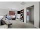 Versatile bonus room includes a TV, shelving, and exercise equipment, perfect for recreation and fitness at 19339 E Mockingbird Dr, Queen Creek, AZ 85142