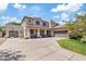 Two-story home featuring a spacious driveway, three-car garage, and charming front porch at 19339 E Mockingbird Dr, Queen Creek, AZ 85142