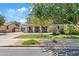 Charming home with lush landscaping, a well-manicured lawn, mature trees, and a spacious driveway at 19339 E Mockingbird Dr, Queen Creek, AZ 85142