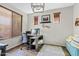 Bright home office with a modern desk, wood floors, and stylish decor accents at 19339 E Mockingbird Dr, Queen Creek, AZ 85142
