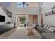 Spacious living room boasts a cozy gray sofa, tall ceilings, and natural light, ideal for relaxation and entertaining at 19339 E Mockingbird Dr, Queen Creek, AZ 85142