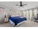 Comfortable bedroom with large bed, ceiling fan, and multiple windows providing ample light at 19339 E Mockingbird Dr, Queen Creek, AZ 85142