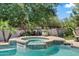 Inviting backyard pool and spa surrounded by lush landscaping and a tranquil atmosphere at 19339 E Mockingbird Dr, Queen Creek, AZ 85142