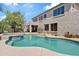 Inviting backyard pool and spa with a covered patio area, perfect for relaxation and outdoor entertaining at 19339 E Mockingbird Dr, Queen Creek, AZ 85142