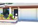 Charming home exterior with a front door, a garage, and decorative landscaping at 2064 S Farnsworth Dr # 38, Mesa, AZ 85209