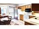 Traditional kitchen with wood cabinets, white appliances, and tile floors offers access to the outside at 2064 S Farnsworth Dr # 38, Mesa, AZ 85209