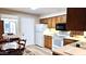 Traditional kitchen with wood cabinets, white appliances, and tile floors offers a cozy eat-in dining space at 2064 S Farnsworth Dr # 38, Mesa, AZ 85209