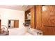 Practical laundry room features overhead cabinets, storage, and connections for appliances at 2064 S Farnsworth Dr # 38, Mesa, AZ 85209