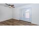 Bright bedroom features hardwood floors, ceiling fan, and glass patio doors at 222 W Brown Rd # 72, Mesa, AZ 85201