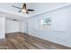 Bright bedroom with wood floors, recessed ceiling, shuttered windows, and ceiling fan at 222 W Brown Rd # 72, Mesa, AZ 85201