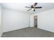 Bedroom features a ceiling fan, neutral carpet, and closet storage at 222 W Brown Rd # 72, Mesa, AZ 85201