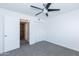 Bedroom features a ceiling fan, neutral carpet, closet, and ensuite access at 222 W Brown Rd # 72, Mesa, AZ 85201