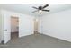Spacious bedroom featuring neutral carpet, ceiling fan, closet and ensuite bathroom access at 222 W Brown Rd # 72, Mesa, AZ 85201