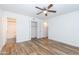 Spacious bedroom featuring wood floors, closet space and a ceiling fan at 222 W Brown Rd # 72, Mesa, AZ 85201