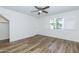 Well-lit bedroom boasting wood flooring, a ceiling fan, and a view of the outdoors at 222 W Brown Rd # 72, Mesa, AZ 85201