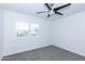 Bedroom features a ceiling fan, neutral carpet and bright, natural light at 222 W Brown Rd # 72, Mesa, AZ 85201