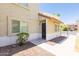 Lovely townhome exterior with a covered porch, desert landscaping, and a secure metal front door at 222 W Brown Rd # 72, Mesa, AZ 85201