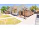 Inviting townhome exterior featuring a lush green lawn, brick wall, and sidewalk at 222 W Brown Rd # 72, Mesa, AZ 85201