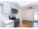 This bright kitchen has stainless appliances, shaker cabinets, and stone countertops at 222 W Brown Rd # 72, Mesa, AZ 85201