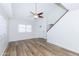 Open living room features wood-look floors, light-filled windows, and a ceiling fan at 222 W Brown Rd # 72, Mesa, AZ 85201