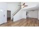 Open-concept living space featuring modern flooring, a staircase, and a ceiling fan at 222 W Brown Rd # 72, Mesa, AZ 85201