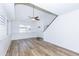 Cozy living room with wood floors, ceiling fan, recessed ceiling and shuttered windows at 222 W Brown Rd # 72, Mesa, AZ 85201