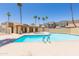 Resort-style pool with palm trees, a cabana, and a hot tub for relaxation and community enjoyment at 222 W Brown Rd # 72, Mesa, AZ 85201