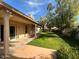 Lush backyard featuring a covered patio and well-maintained lawn, perfect for outdoor entertaining at 2301 E Beachcomber Dr, Gilbert, AZ 85234