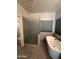 Modern bathroom features a glass shower, tile surround soaking tub and neutral color palette at 2301 E Beachcomber Dr, Gilbert, AZ 85234