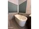 Bright bathroom boasts a luxurious soaking tub beneath windows at 2301 E Beachcomber Dr, Gilbert, AZ 85234