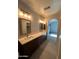 Expansive bathroom features a double sink vanity with dark wood cabinets and tile flooring at 2301 E Beachcomber Dr, Gilbert, AZ 85234