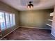 Bedroom with wood floors, light-green walls, ceiling fan, and window with shutters at 2301 E Beachcomber Dr, Gilbert, AZ 85234