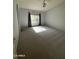 Bright and airy bedroom with neutral walls, carpet, and window at 2301 E Beachcomber Dr, Gilbert, AZ 85234