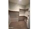 Spacious walk-in closet with built-in shelving and hanging racks for maximum storage at 2301 E Beachcomber Dr, Gilbert, AZ 85234