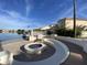 This lakeside fire pit provides a cozy outdoor gathering space with scenic views of the water and surrounding community at 2301 E Beachcomber Dr, Gilbert, AZ 85234