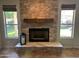 Stone fireplace with mantel, hearth, and windows on either side for natural light at 2301 E Beachcomber Dr, Gilbert, AZ 85234