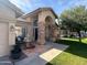 Inviting single-Gathering home with manicured lawn, brick accents, and a charming water fountain at 2301 E Beachcomber Dr, Gilbert, AZ 85234