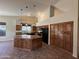 Spacious kitchen features a large center island, granite countertops, and ample cabinet space for storage at 2301 E Beachcomber Dr, Gilbert, AZ 85234