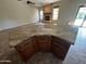 Features a large kitchen island with granite countertops and open living room with fireplace at 2301 E Beachcomber Dr, Gilbert, AZ 85234