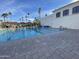 Well-maintained lap pool with clear blue water, poolside seating, and a clubhouse in a sunny community at 2301 E Beachcomber Dr, Gilbert, AZ 85234