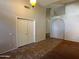 Living room showcasing tile floors, closet doors, archway, and neutral wall paint at 2301 E Beachcomber Dr, Gilbert, AZ 85234