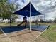 Community playground with colorful play equipment and shade covering for children at 2301 E Beachcomber Dr, Gilbert, AZ 85234