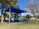 Community playground with blue covering and modern play equipment on a sunny day at 2301 E Beachcomber Dr, Gilbert, AZ 85234