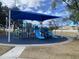 Community playground featuring slides, climbing structures, and shaded area for fun at 2301 E Beachcomber Dr, Gilbert, AZ 85234