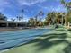 A vibrant blue and green tennis court awaits players for recreational and competitive matches in a well-maintained community at 2301 E Beachcomber Dr, Gilbert, AZ 85234