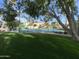 An inviting tennis court with manicured lawn, offering a recreational amenity for active residents at 2301 E Beachcomber Dr, Gilbert, AZ 85234