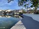 Beautiful waterfront community featuring homes, palm trees, and a lake for boating activities on a sunny day at 2301 E Beachcomber Dr, Gilbert, AZ 85234