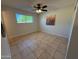 Bright bedroom with tile floors, ceiling fan, and natural light at 2331 W Via Rialto Cir, Mesa, AZ 85202