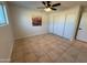 Bedroom with tile floors, ceiling fan, and closet at 2331 W Via Rialto Cir, Mesa, AZ 85202