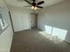 Bedroom with neutral carpet, a window, ceiling fan, closet, and neutral paint at 2331 W Via Rialto Cir, Mesa, AZ 85202